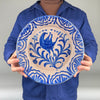Person holding a blue and white Vintage 30 cm Fajalauza bowl highlighting cobalt heraldic falcon and fan-pattern border, ideal for Mediterranean decor, rustic home decor, cottage displays, Japandi decor and collectors of Andalusian faience.