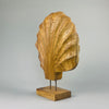 Angled shot of the wooden shell sculpture mounted on its base, revealing the handcrafted asymmetry, fluted ridges, and gentle curves. Perfect for placement in Wabi-Sabi homes, earthy interiors, or serene Japandi-style living rooms and entryways.