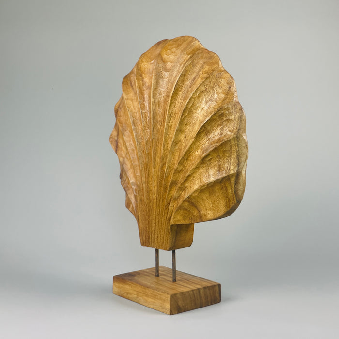 Angled shot of the wooden shell sculpture mounted on its base, revealing the handcrafted asymmetry, fluted ridges, and gentle curves. Perfect for placement in Wabi-Sabi homes, earthy interiors, or serene Japandi-style living rooms and entryways.
