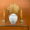 Lifestyle image of antique French white confit pot styled as a centerpiece with decorative wood carvings. Martres Tolosane pottery circa 19th century. Pot à conserve vessel suitable for display as rustic urn or farmhouse French storage jar in modern interiors.