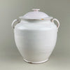 Antique Martres Tolosane confit pot shown with lid removed, highlighting wide rim and interior glaze. Traditional pot à conserve design, white ceramic glaze with wear and patina. A French rustic urn-style storage jar suited for decorative or practical display.