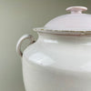 Close-up of side handle detail on antique French white confit pot, showing glaze imperfections and firing marks. Late 19th-century Martres Tolosane craftsmanship. Functional as rustic storage jar or styled as an antique decorative urn in farmhouse interiors.