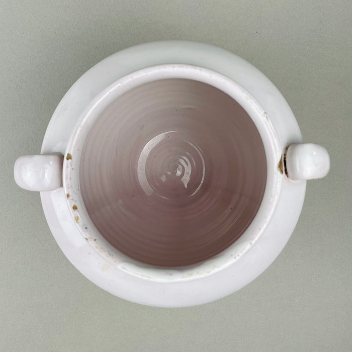 Close-up of rim detail on antique French confit pot lid, showing glaze wear and patina. Made in Martres Tolosane in the late 1800s. Pot à conserve storage jar doubling as rustic urn decor, valued for authenticity and provincial French character.