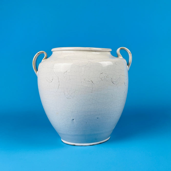 Antique French confit pot made of white glazed stoneware pottery with craquelure glaze and two side handles, originating from Martres Tolosane France. Its aged glaze confirms authenticity and makes it ideal for farmhouse decor or wabi sabi interiors.