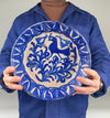 Full frontal view of a 19th-century Fajalauza ceramic wall bowl with pierced hanging holes, allowing use as wall hanging ceramic decor or display on a shelf or table. The bold cobalt brushwork and folk bird motif make it suitable for Mediterranean Decor, Coastal Decor, and Cottage Decor, while the handmade irregularities align with Wabi Sabi decor aesthetics.
