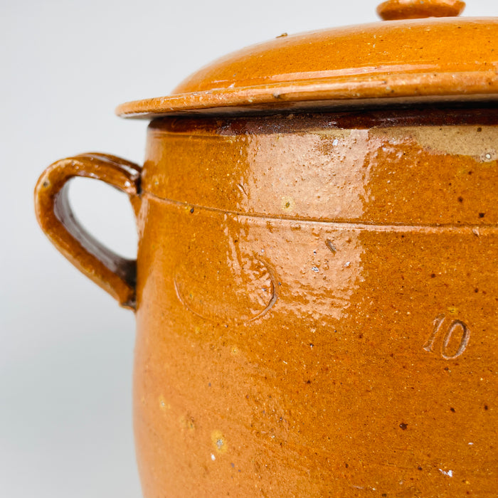 Rare complete French confit pot consisting of a large wheel-thrown terracotta crock and original fitted lid, both covered in glowing ochre glaze. Signed Foucard Jourdan Vallauris A.M., this early 20th century marmite represents Provence pottery made for hearth cooking and now suits Mediterranean decor or an antique kitchen collection.