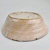 Underside view of the antique Spanish tin-glazed lebrillo, documenting the unglazed foot, terracotta clay tone, and firing marks consistent with traditional Granada production. This Fajalauza pottery bowl is ideal as wall hanging ceramic decor, a table centerpiece, or a serving bowl for Wabi Sabi decor and Japandi interiors that value handmade imperfection.
