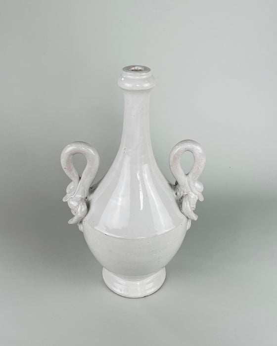 Large Italian ceramic vase in glossy white glaze, with an ovoid footed body and one applied swan ornament fully visible as the bird’s curved neck forms the handle. Dating to circa the 1950s to 1960s, this sculptural vase offers a distinctive vintage focal piece for classical decor or a console display with dried stems.