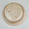 Underside view of the antique Spanish tin-glazed lebrillo, documenting the unglazed foot, terracotta clay tone, and firing marks consistent with traditional Granada production. This Fajalauza pottery bowl is ideal as wall hanging ceramic decor, a table centerpiece, or a serving bowl for Wabi Sabi decor and Japandi interiors that value handmade imperfection.