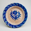 Antique Spanish Fajalauza lebrillo bowl photographed front-on, showing cobalt blue bird and floral decoration on a cream ground. The softly diffused cobalt edges result from authentic kiln firing, where pigment bleeds into the tin glaze, creating depth and movement. Suitable as wall hanging ceramic, table centerpiece, or serving bowl for Rustic Home Decor, Mediterranean Decor, French Country Decor, Cottage Decor, Farmhouse Decor, Wabi Sabi decor, and Japandi interiors.