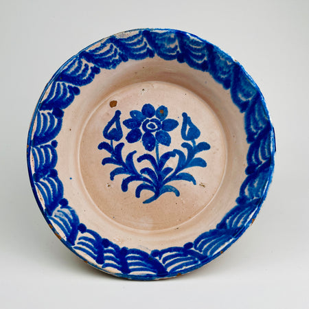 Antique Spanish Fajalauza lebrillo bowl photographed front-on, showing cobalt blue bird and floral decoration on a cream ground. The softly diffused cobalt edges result from authentic kiln firing, where pigment bleeds into the tin glaze, creating depth and movement. Suitable as wall hanging ceramic, table centerpiece, or serving bowl for Rustic Home Decor, Mediterranean Decor, French Country Decor, Cottage Decor, Farmhouse Decor, Wabi Sabi decor, and Japandi interiors.