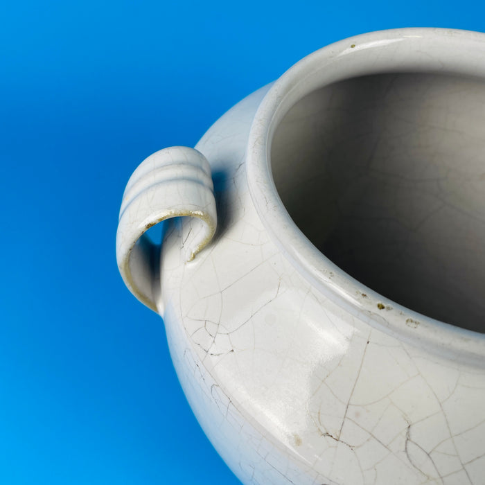 Rear view showing the curved double handles and oxidized glaze transitions, illustrating the artisanal hand-thrown nature of this antique French pottery vessel from southwestern France.
