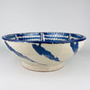 Vintage Spanish Fajalauza bowl from Granada in glazed earthenware, featuring a cream white ground with bold cobalt blue decoration. The interior shows a central floral medallion surrounded by rhythmic wavy bands, while the large basin shape gives it strong presence as a ceramic centerpiece, wall hanging bowl, or decorative accent in Mediterranean decor and French country decor.