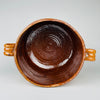 Large lidded Vallauris marmite in glazed terracotta, with the number 10 size mark visible between its symmetrical handles and a warm honey brown surface developed through age and use. This signed antique French pottery crock by Foucard Jourdan is an authentic Provence cooking vessel and distinctive kitchen centerpiece.