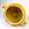French yellow glazed confit pot in antique terracotta, a rustic kitchen vessel with strong sculptural character. The interior glazing and upper glaze band contrast with the unglazed lower body, a hallmark of traditional French pottery jars. With its loop handles, warm ochre tones, and age-softened finish, it works beautifully in farmhouse decor, country kitchen decor, and Mediterranean decor.