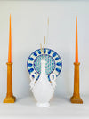 Sculptural swan handle on an Italian white ceramic vase from circa the 1950s to 1960s, modeled with a looping neck, pointed beak and folded wings over the shoulder of the vessel. The glossy glaze shows small firing imperfections and surface wear that preserve the tactile character of the vintage pottery.