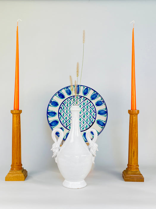 Sculptural swan handle on an Italian white ceramic vase from circa the 1950s to 1960s, modeled with a looping neck, pointed beak and folded wings over the shoulder of the vessel. The glossy glaze shows small firing imperfections and surface wear that preserve the tactile character of the vintage pottery.