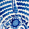 The broad circular scale of this Spanish Fajalauza bowl emphasizes its substantial presence as a decorative object. Hand painted cobalt blue waves, a central sunflower, and scrolling foliage fill the white glazed interior, while the traditional lebrillo depth gives the piece sculptural volume. It works as statement wall art, a fruit bowl, or a large table centerpiece for Mediterranean decor and vintage home decor.