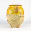 Large antique French confit jar in earthenware with yellow glaze and classic rural pottery form. This 19th century French pottery vessel has two loop handles, a rolled lip, and a hand-thrown body with strong surface patina. The crackled glaze, worn edges, and exposed clay create a decorative terracotta jar that works beautifully in French country decor and wabi sabi decor.
