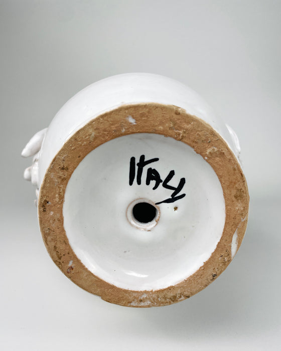Underside of the vintage Italian ceramic vase showing the broad unglazed earthenware foot ring, glossy recessed base, handwritten ITALY mark and centered aperture. The worn foot and small glaze losses record use and age, while the visible national mark directly supports the Italian provenance of this mid 20th century piece.