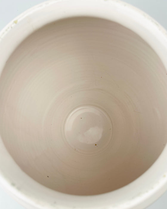 Large antique French preserve jar from Martres Tolosane with creamy white glaze over a warm buff earthenware body. The rounded wheel thrown profile, paired handles and wide mouth belong to the regional confit pot tradition, while rim and handle wear record domestic use and suit authentic rustic home decor.
