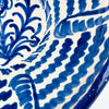 Traditional Fajalauza bowl in glazed terracotta earthenware, with cobalt blue brushwork arranged around a central sunflower and flowing leafy stems. Repeated wave patterns and segmented motifs spread across the interior, giving the large circular bowl a lively handmade character. Suitable as Spanish wall art, a ceramic centerpiece, or a decorative bowl, it fits vintage home decor, cottage decor, and French country decor.