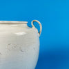 Macro detail of the aged craquelure glaze—a web of fine surface cracks developed naturally over time—representing the hallmark of antique French provincial pottery and adding depth to wabi sabi home styling.