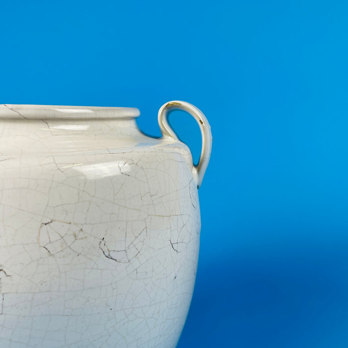 Macro detail of the aged craquelure glaze—a web of fine surface cracks developed naturally over time—representing the hallmark of antique French provincial pottery and adding depth to wabi sabi home styling.