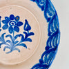 Detail view of the scalloped rim border on a Fajalauza Granada lebrillo, showing hand-painted cobalt lines with softly blurred edges from traditional kiln firing. This antique Spanish ceramic wall bowl can be displayed as wall hanging ceramic, styled as a table centerpiece, or used as a decorative serving bowl in Mediterranean Decor and Coastal Decor homes.
