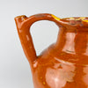 Large French gargoulette pot in brown glazed terracotta, originally made for carrying, storing and pouring household water. Its full rounded belly and unusual twin arched profile create a bold decorative vessel for French country decor, while worn edges and glaze losses retain the character of everyday rural use.