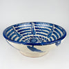 Detail of the interior decoration on a Spanish Fajalauza lebrillo bowl, showing the hand painted floral motif at the center with scrolling foliage in deep cobalt blue. The creamy glaze, free brushwork, and traditional Granada pottery design give this ceramic bowl an authentic artisan character. It is a strong choice for Mediterranean decor, vintage home decor, and collected ceramic displays.