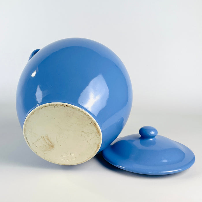 Blue-glazed vintage French pottery jar with lid, made in the Martres Tolosane tradition during the mid 20th century. The full rounded body, narrow circular foot, short rim and two handles form a self-contained sculptural vessel for shelf styling, table centerpiece use, vintage home decor or decorative kitchen storage.