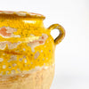 French country confit pot in terracotta, dating to the 19th century, with a generous rounded body and small side handles. The yellow ochre glaze shows heavy craquelure, chips, and glaze loss that reveal the warm clay underneath. This antique French jar is ideal for French country decor, farmhouse decor, and rustic kitchen styling where aged pottery adds depth and warmth.