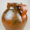 Detail of the right handle and upper body on a large terracotta pot, with semi-gloss brown glaze over red clay and visible firing speckles. The handle’s squared profile emphasizes the utilitarian heritage while presenting as vintage home decor today, ideal for Mediterranean decor shelving or French provincial styling.