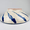 The reverse of this large Spanish Fajalauza lebrillo reveals a raised circular foot, the warm terracotta clay beneath the pale glaze, and loose cobalt blue exterior brush motifs. A pierced hanging hole near the foot allows the bowl to be mounted securely as wall decor. The construction and finish identify it as Granada pottery and make it suitable for Mediterranean decor and collected vintage ceramics.