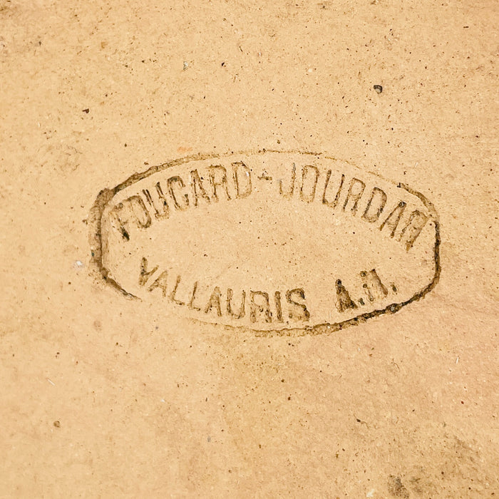 Clear impressed base stamp reading FOUCARD JOURDAN above VALLAURIS A.M. on the unglazed terracotta underside. This maker’s mark authenticates the large French marmite as Vallauris pottery from Alpes-Maritimes in Provence and supports its identity as signed antique culinary earthenware rather than a modern decorative planter.
