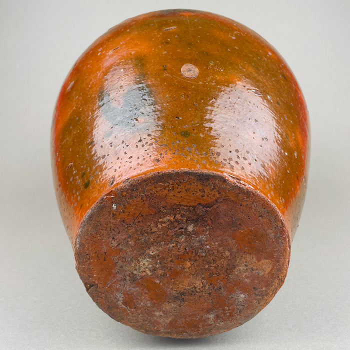 Underside and base view of the antique terracotta pot, showing the unglazed foot ring, kiln wear, and age-related abrasions from use. The heavy clay construction and stable base make it practical as a floor or hearth decorative pottery accent, suited to farmhouse decor and French country decor.