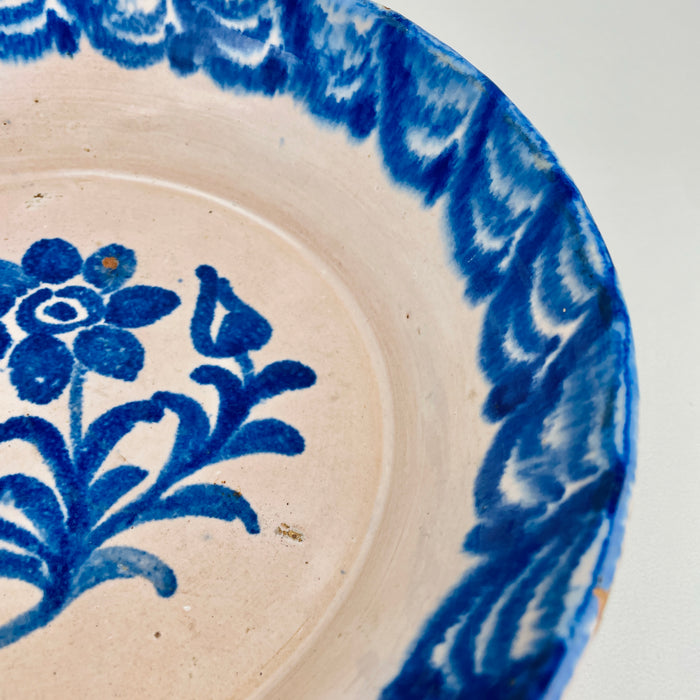 Detail view of the scalloped rim border on a Fajalauza Granada lebrillo, showing hand-painted cobalt lines with softly blurred edges from traditional kiln firing. This antique Spanish ceramic wall bowl can be displayed as wall hanging ceramic, styled as a table centerpiece, or used as a decorative serving bowl in Mediterranean Decor and Coastal Decor homes.