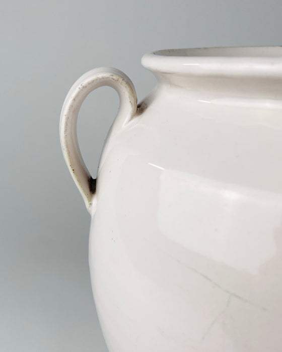 Extra large antique French white confit pot measuring 25 cm high and 28 cm wide handle to handle, with a substantial weight of 2.8 kg. This early 20th century Martres Tolosane faience jar combines a full rounded body, wide opening, twin loop handles and soft ivory glaze, a less commonly encountered large-scale form among regional preserve pots.