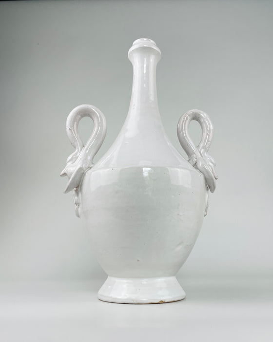  vintage Italian white ceramic vase, with both swan handles visible around the rounded shoulder. Minor rim nicks and exposed warm clay appear at the mouth, while the deep interior channel supports display with dried stems or a potential lamp base conversion.