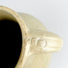Large French provincial pottery jug with a bulbous shoulder, tall tapering body and warm white glaze over wheel-thrown clay. The restrained palette, handmade asymmetry and timeworn lower edge give the early 1900s decorative vessel a calm sculptural quality compatible with Mediterranean decor and natural materials.