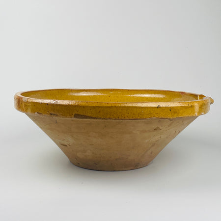 Antique French tian bowl in large 39cm size shown upright with warm yellow glaze and traditional pouring notch, highlighting rustic terracotta craftsmanship from the South of France. Ideal for farmhouse kitchen styling, Mediterranean interiors, and French country decor, adding authentic utilitarian pottery character to shelves or kitchen tables.