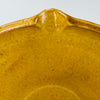 Handmade vintage French tian bowl in terracotta with soft golden glazing shown close-up to reveal glaze variation, historical wear, and artisanal form. Works as a functional bread bowl or as a centrepiece in Mediterranean rustic decor, contemporary wabi-sabi homes, and French country kitchens seeking grounded materials.
