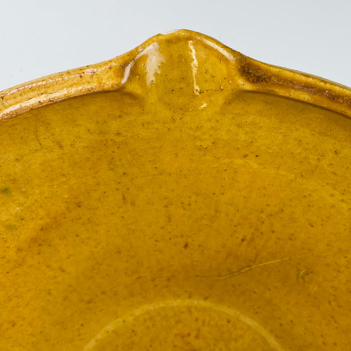 Handmade vintage French tian bowl in terracotta with soft golden glazing shown close-up to reveal glaze variation, historical wear, and artisanal form. Works as a functional bread bowl or as a centrepiece in Mediterranean rustic decor, contemporary wabi-sabi homes, and French country kitchens seeking grounded materials.
