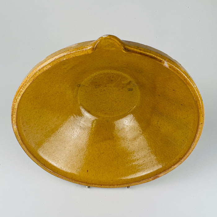 Provincial French tian bowl from the 1800s in ochre glaze, photographed with subtle patina that reflects centuries of domestic use. Ideal for French farmhouse styling, Mediterranean interior design, and organic modern spaces where oversized rustic ceramics act as sculptural, warm-toned focal points.