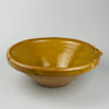 Large antique French terracotta tian bowl with deep yellow slip glaze, showing aged patina and provincial craftsmanship from Occitanie and Provence pottery traditions. Works beautifully in wabi-sabi and French country kitchens as a sculptural serving bowl or decorative centrepiece, adding texture and earth-tone authenticity to curated spaces.