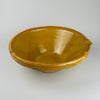 Large antique French pottery tian bowl with classic rounded base and warm yellow glaze, styled to highlight its heritage as traditional Southern French cookware. Ideal for organic modern interiors and farmhouse decor where natural clay textures and generously scaled ceramic pieces enhance kitchen or dining spaces