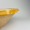 South-of-France terracotta tian bowl with distinctive pouring indentation and glossy ochre glaze, perfect for farmhouse food styling or as a sculptural decorative bowl. Complements minimalist rustic interiors, wabi-sabi collections, and Mediterranean home decor with its simple handcrafted form and generous size.