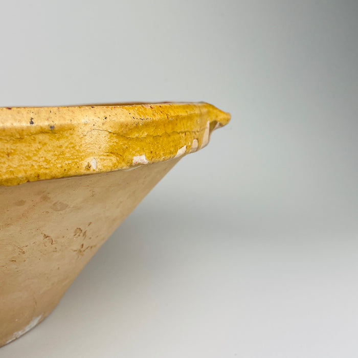 South-of-France terracotta tian bowl with distinctive pouring indentation and glossy ochre glaze, perfect for farmhouse food styling or as a sculptural decorative bowl. Complements minimalist rustic interiors, wabi-sabi collections, and Mediterranean home decor with its simple handcrafted form and generous size.