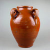 Antique Spanish terracotta orza with four sculptural handles and a rich red-brown glaze, hand-thrown in Toledo, Spain during the early 20th century. The vessel’s glossy surface and traditional form highlight Mediterranean pottery craftsmanship, perfect for rustic farmhouse or wabi sabi interiors.